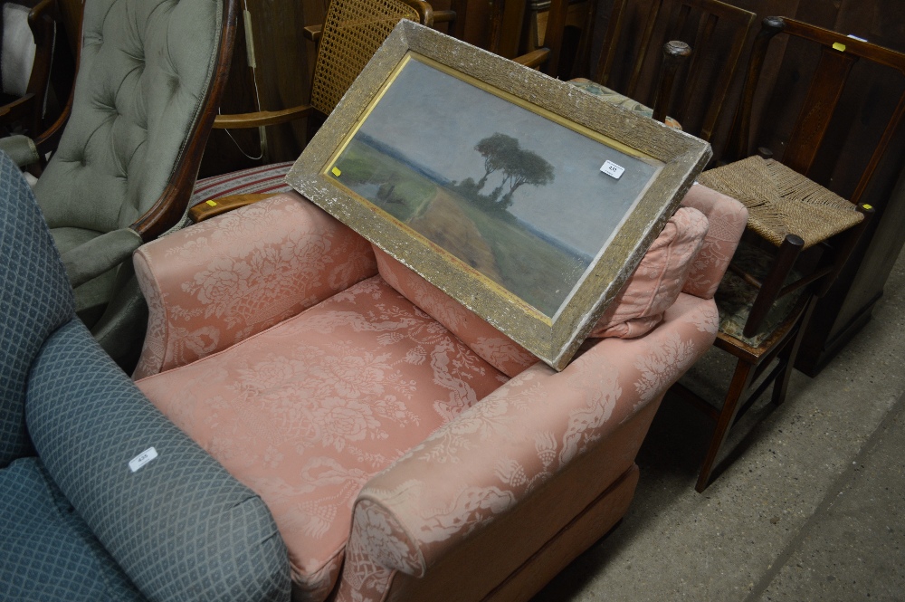 A pink upholstered arm chair