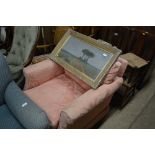 A pink upholstered arm chair