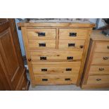 A good quality light oak chest, fitted four short