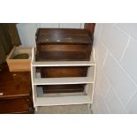 A small oak bookcase and a set of white painted wa