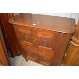 An oak side cabinet with lift-up top