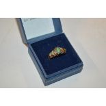 A 9 carat gold green stone set ring