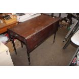 A 19th Century mahogany Pembroke table raised on tapering suppo