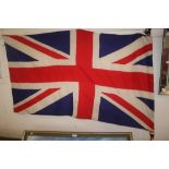 A large Union Jack flag attached with a pine pole