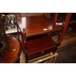 A reproduction mahogany bedside table