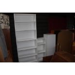 A tall open fronted bookcase together with one sma