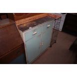 A white and blue painted kitchen cupboard