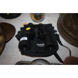 A pair of binoculars in carrying case