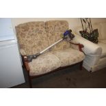 A floral upholstered two seater settee