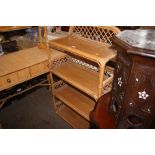 A cane four tier open fronted bookcase