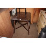 A dark Ercol drop leaf dining table