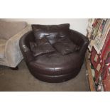 A large brown leather swivel chair