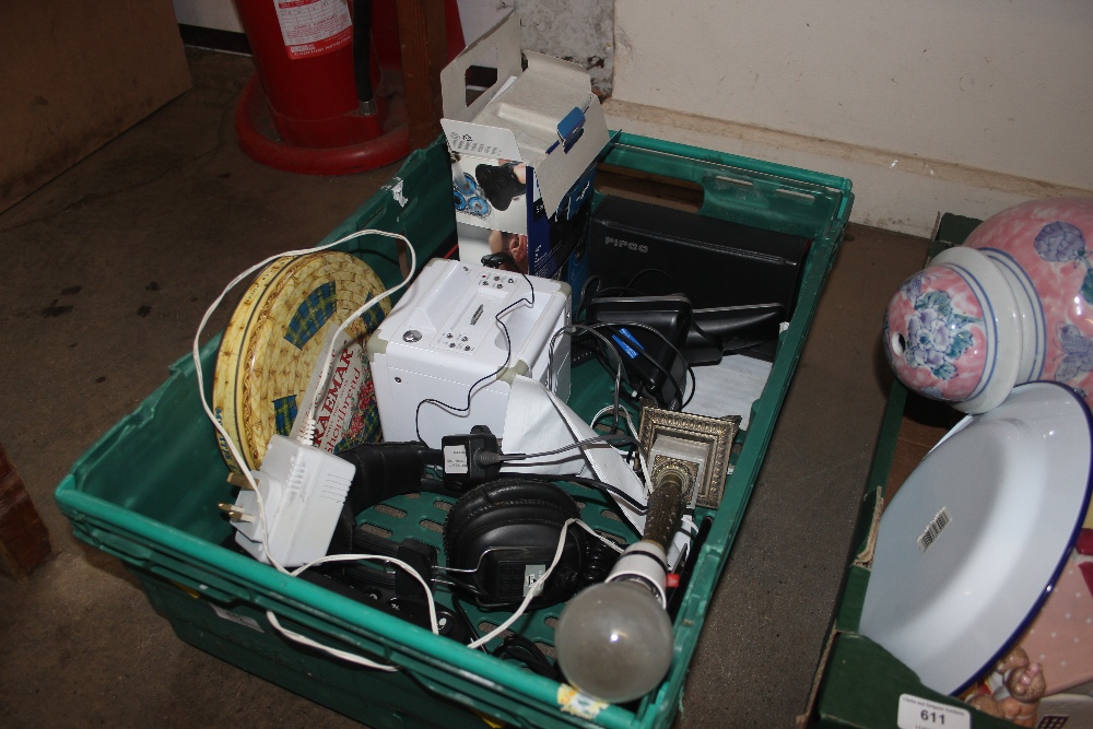 A crate containing a pair of headphones; telephone