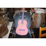 A pink acoustic guitar