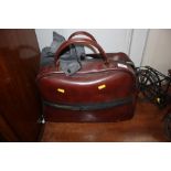 A leather bag containing bowling woods and shoes e