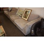 An upholstered three seater sofa