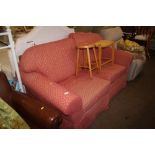 A pink upholstered settee