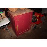 A red painted single door cupboard