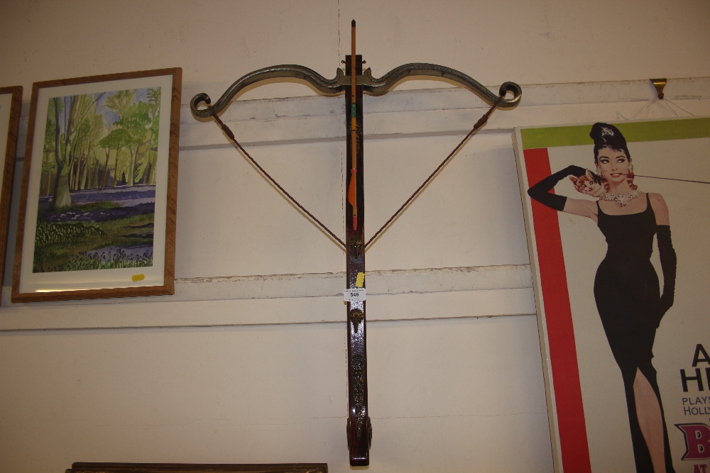 A decorative wall hanging in the form of a crossbo