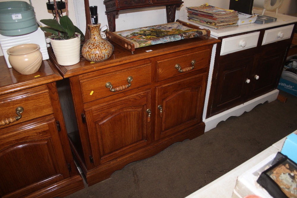 A continental style oak side cupboard fitted two d
