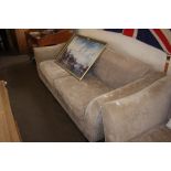 An upholstered three seater sofa