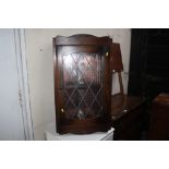 A leaded glazed corner cabinet