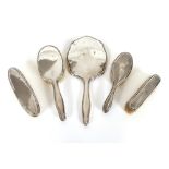 Five pieces of silver and Continental white metal dressing tableware, comprising mirror and brushes