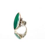 A silver and green gemstone set ring, of navette shape