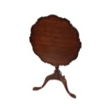A 19th Century mahogany pie crust bordered snap top occasional table, raised on a foliate carved