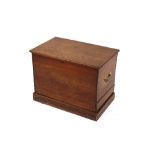 A 19th Century oak blanket box, flanked by brass carrying handles and raised on a platform plinth,