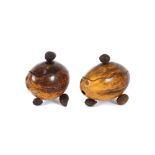 A pair of carved coconut boxes, with removable lids and nut finials, 10cm high