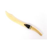 An early 20th Century ivory and horn letter opener, in the form of a scimitar, 27cm long