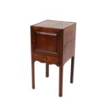 A 19th Century mahogany bedside cupboard, enclosed by single fielded panel door above shallow