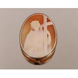 A large 19th Century carved cameo shell of Mary carrying the cross, in a heavy gold frame, stamped 9