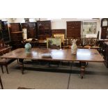 A large Victorian mahogany extending dining table, fitted five extra leaves, raised on bold baluster