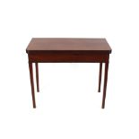 A 19th Century mahogany fold-over tea table, the rectangular top raised on square tapering supports,