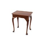 A 19th Century walnut side table, the shallow tray top raised on shell shoulders and cabriole