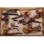 A collection of various Bavarian pipes, including Meerschaum examples, one in the form of a deer