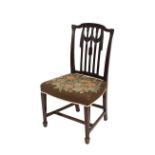 A George III mahogany dining chair, having carved swag decoration to the rail back, floral