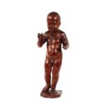 A 19th Century carved wooden study of an infant, 60cm high, (some damage)