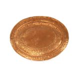 A late 19th/early 20th Century Arts & Crafts copper oval serving tray, decorated with bark ornament,