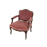 A French mahogany framed armchair, having rouge Dralon upholstered back, seat and arm rests,