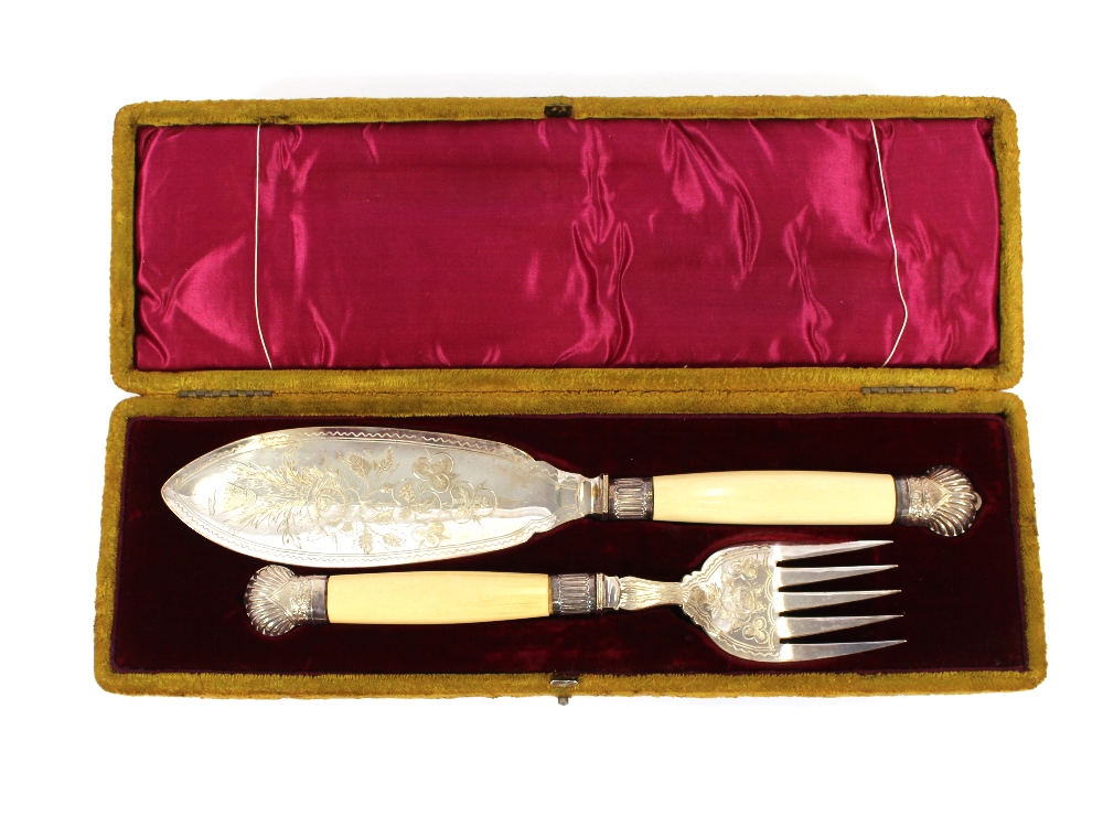 A cased pair of Victorian plated fish servers, having foliate decoration and silver ferrules