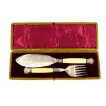 A cased pair of Victorian plated fish servers, having foliate decoration and silver ferrules