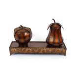 A Toleware gilded tea caddy, in the form of a pear; another in the form of an apple, both raised