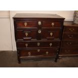 An Antique oak chest, in two sections, fitted four long drawers with geometric moulded panel