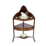 An Edwardian mahogany corner washstand, fitted single drawer below, raised on outswept supports