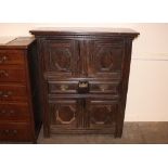 An Antique oak dole or food cupboard, enclosed by two pairs of geometric panelled doors around a