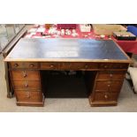 A Victorian oak pedestal writing desk, the leatherette inset top fitted three drawers, with three