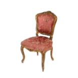 A 19th Century French gilt framed side chair, the shaped back with foliate cresting, floral